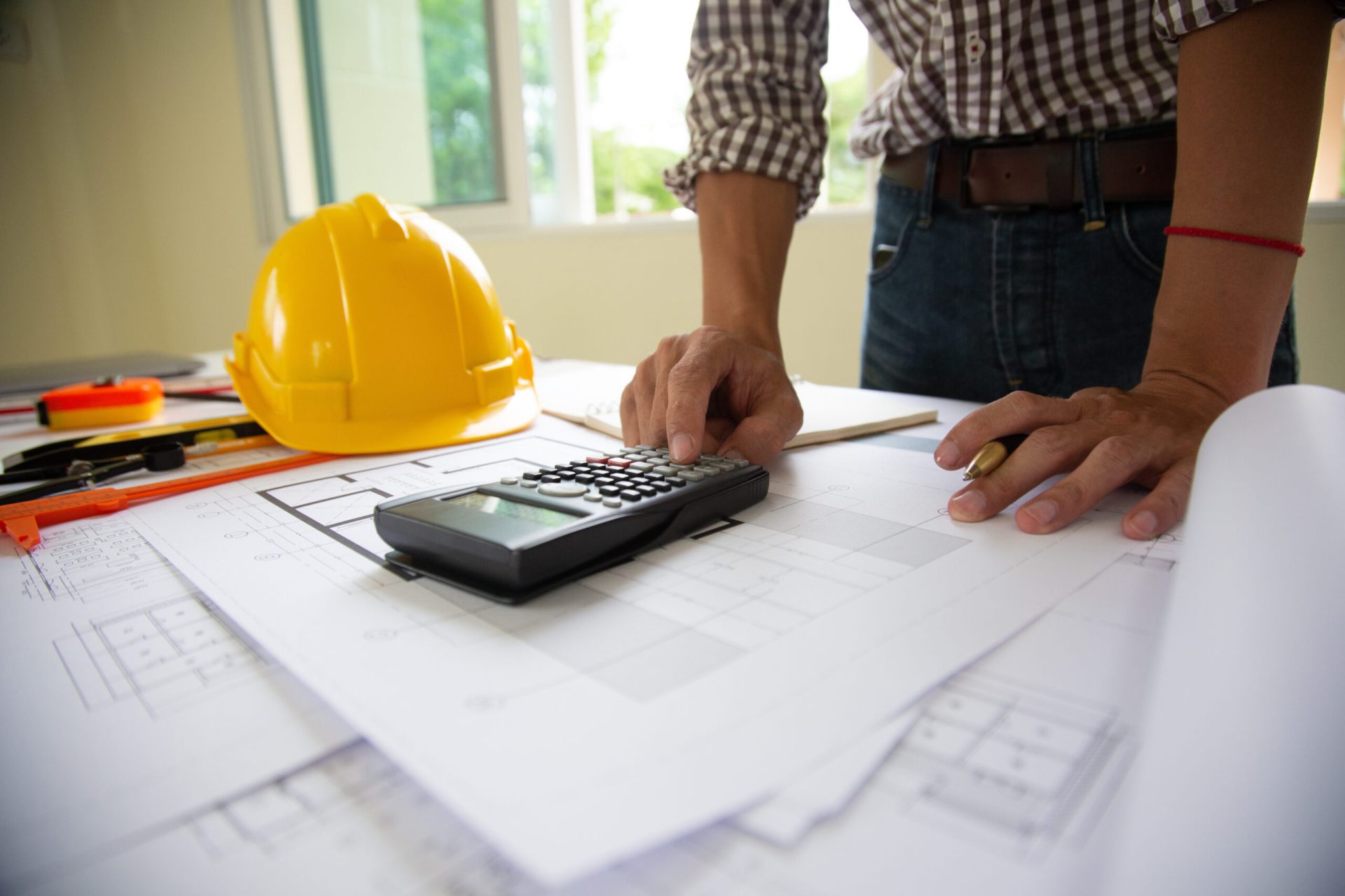 hand engineers are writing home construction designs to bring them to prospective customers.