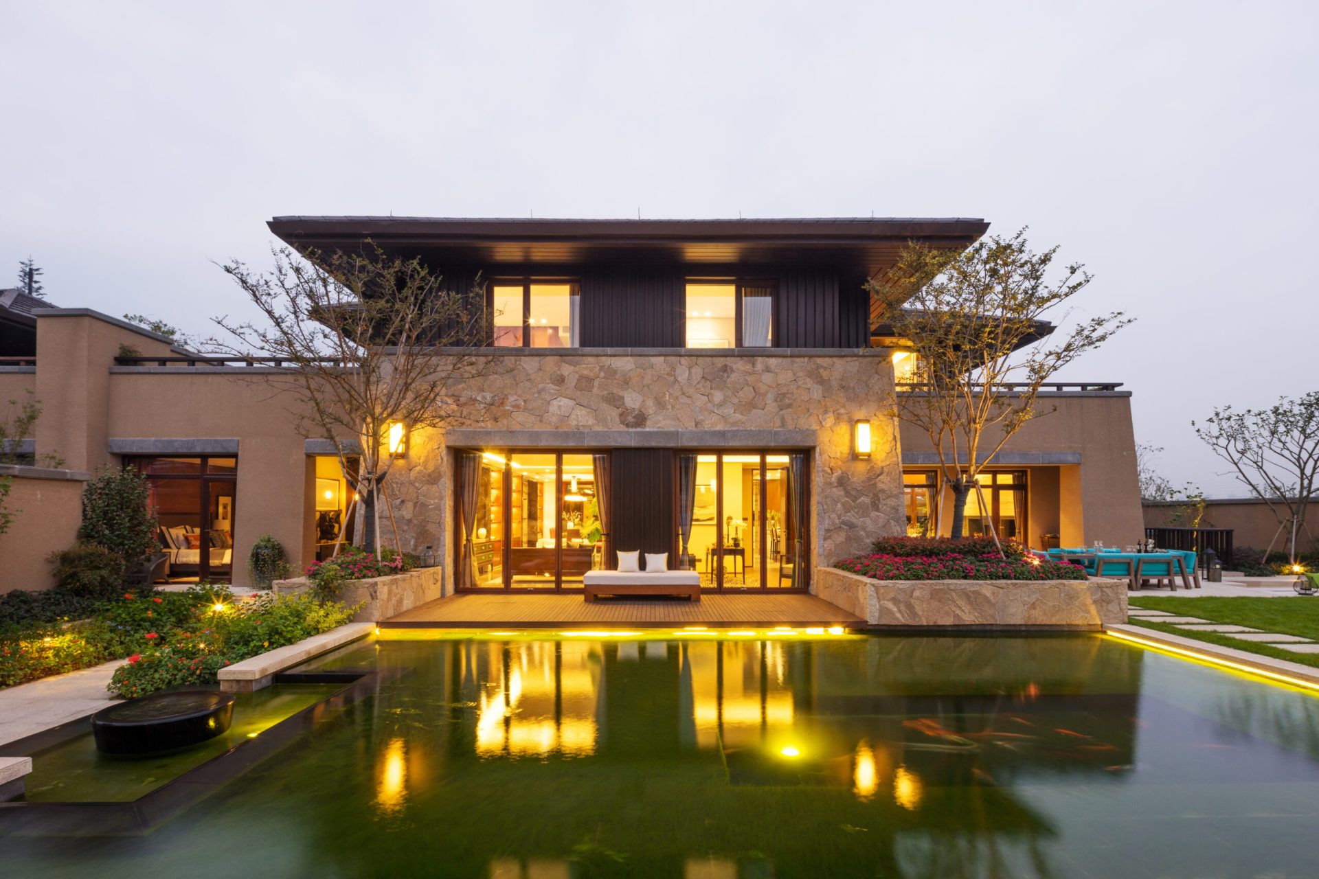 facade of modern building near pond at dusk